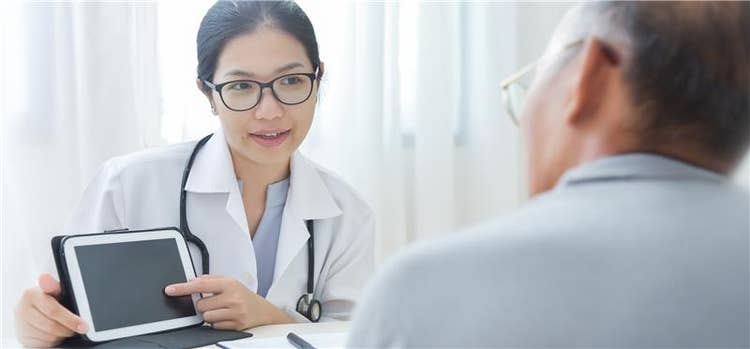Female doctor conversing with male patient.