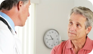 Doctor conversing with a patient.