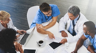 Three male doctors conversing.