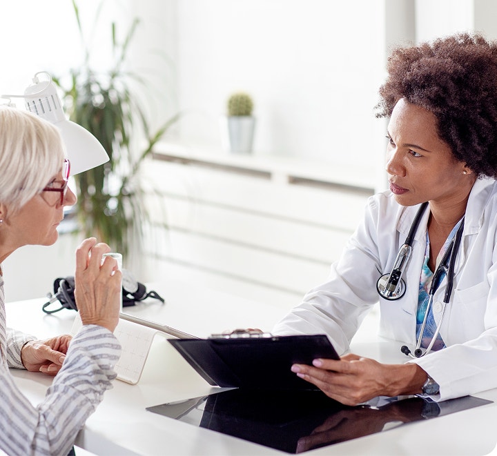 Female doctor conversing with a female patient.